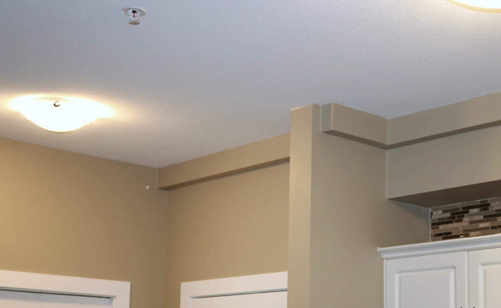 Track routed around a structural column and kitchen walls