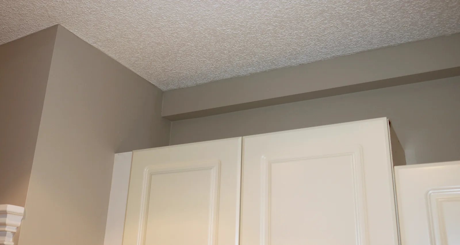 Track running above existing kitchen cabinetry