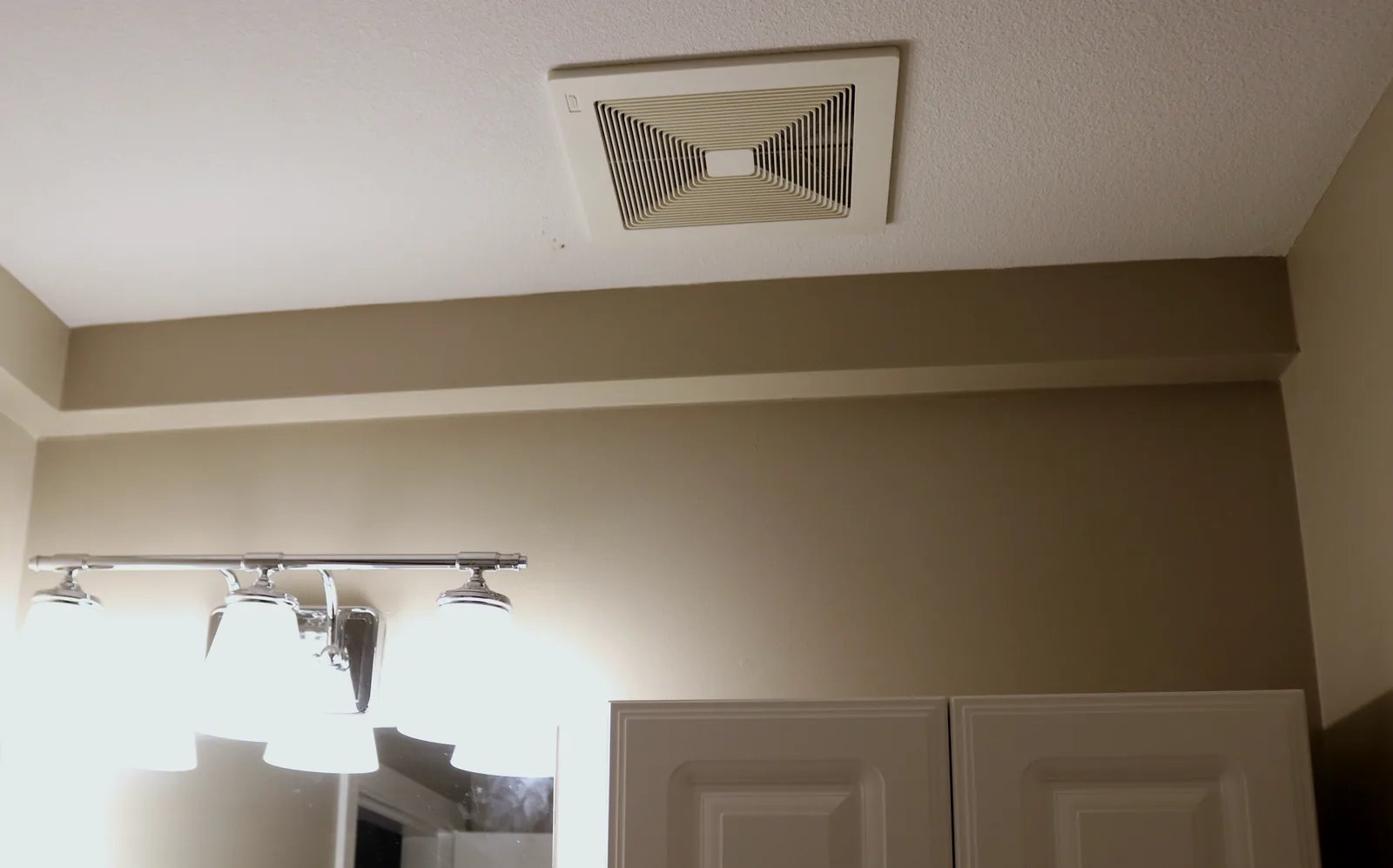 Track continuing through a bathroom below the ceiling vent