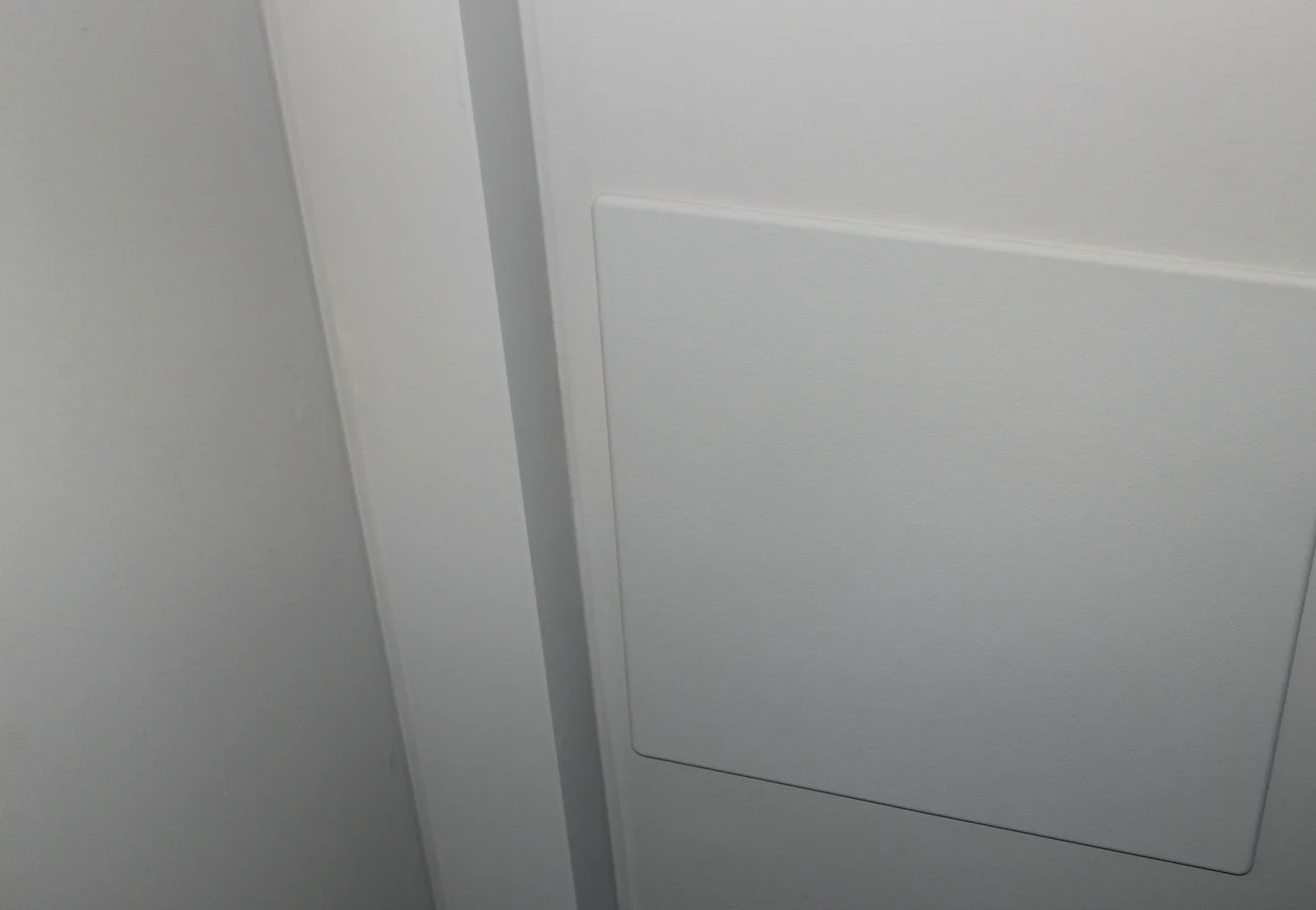 Flush access panel in a finished Plumbing Track enclosure