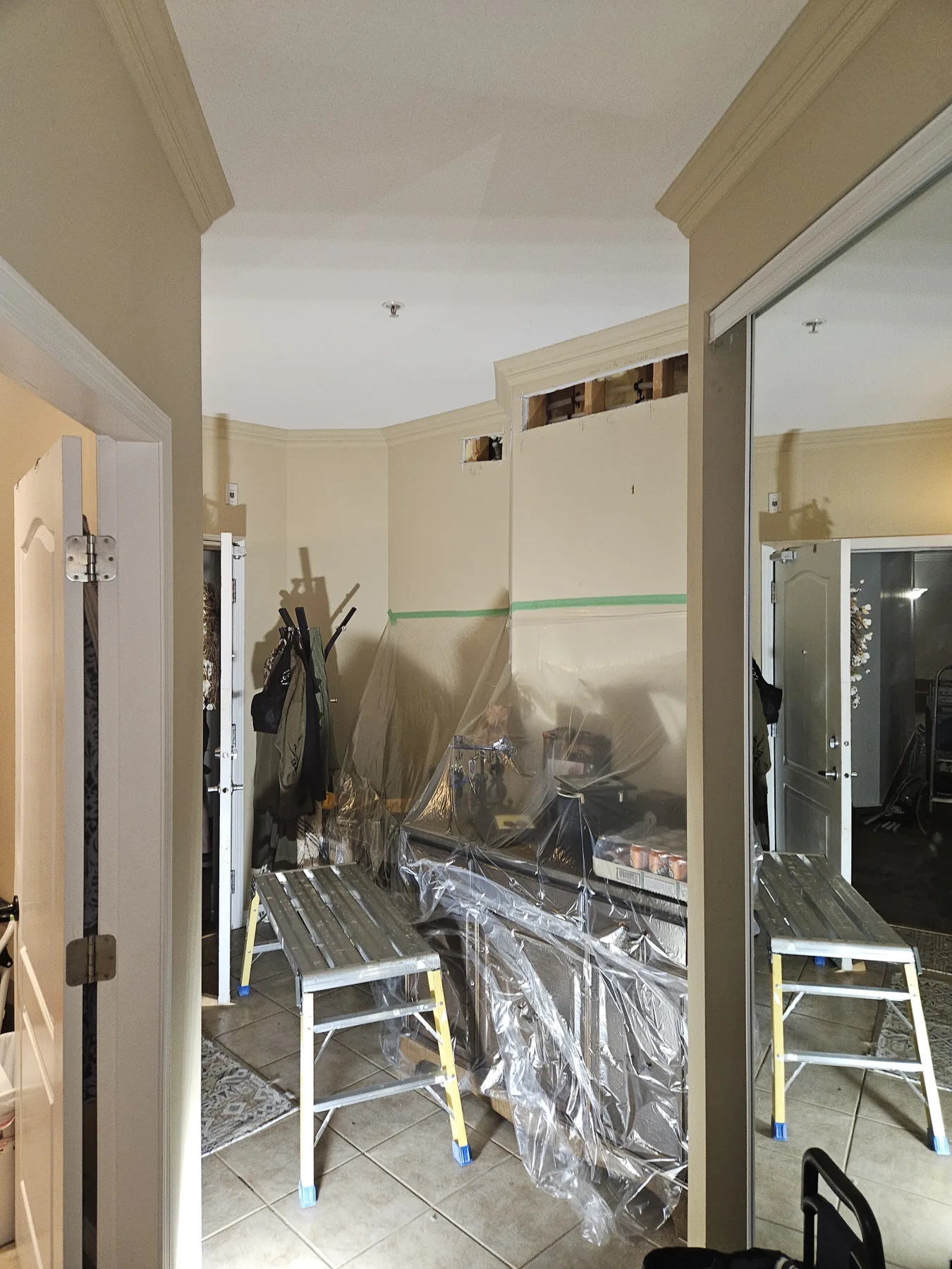 Protected occupied-suite work area prepared for Plumbing Track installation